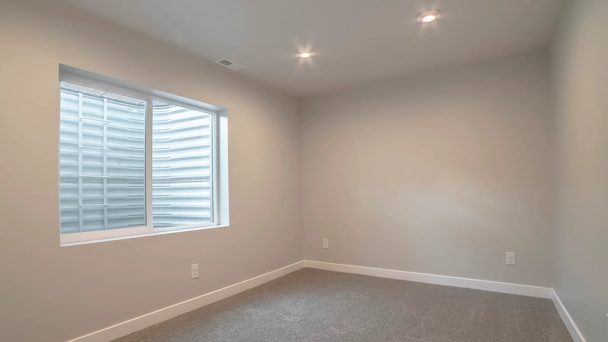 Finished basement room with recessed lighting by DMV Home Improvement