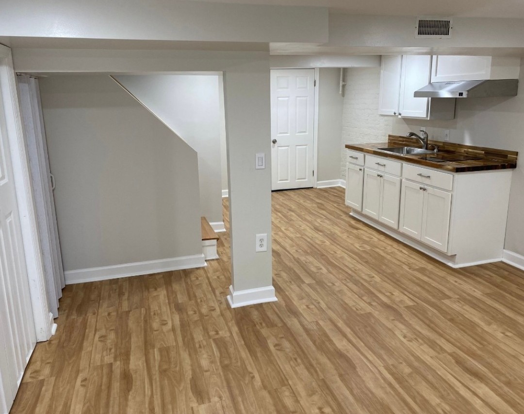 Basement kitchenette with vinyl plank flooring