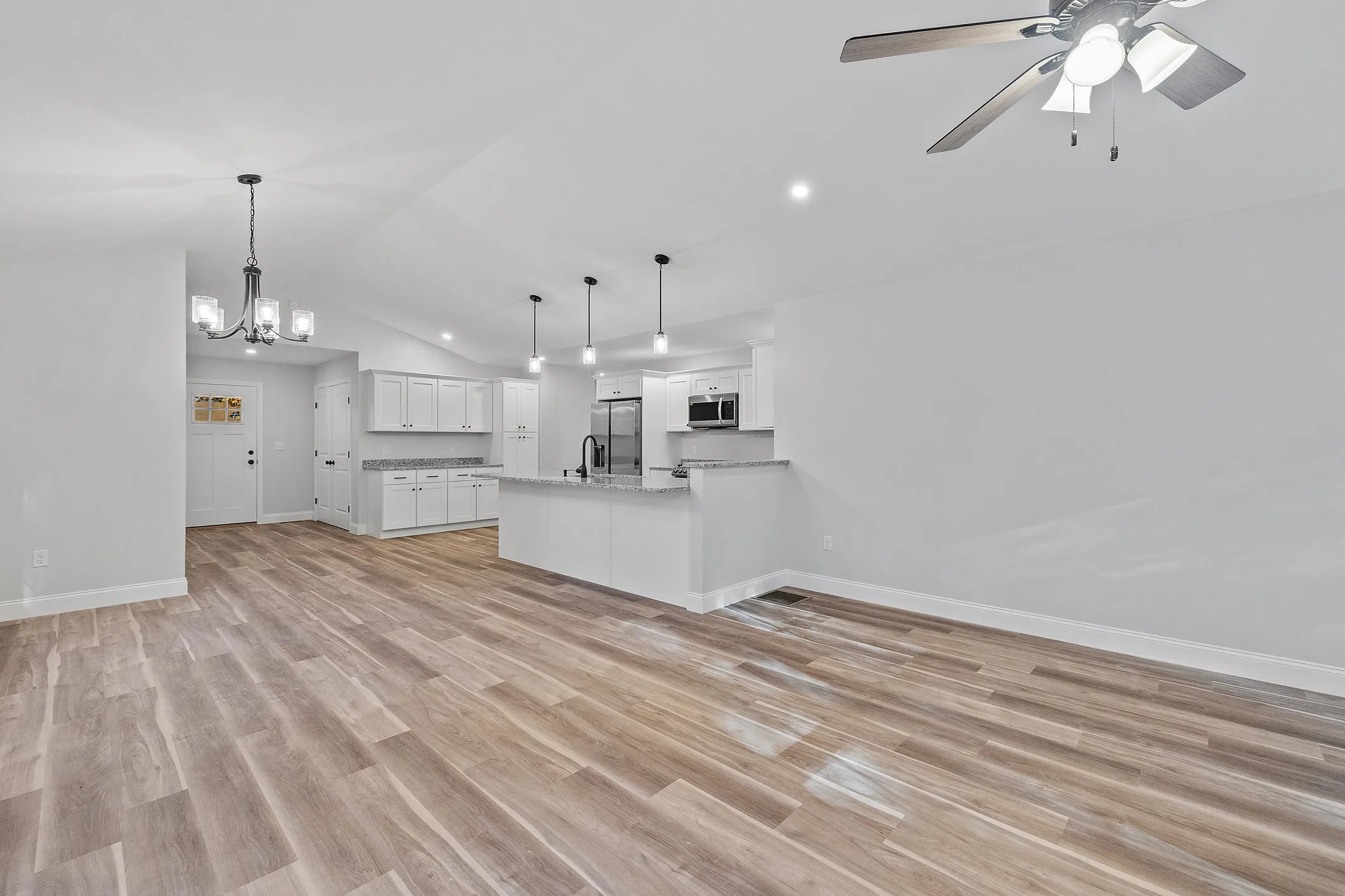 Open concept basement finishing with modern flooring by DMV Home Improvement