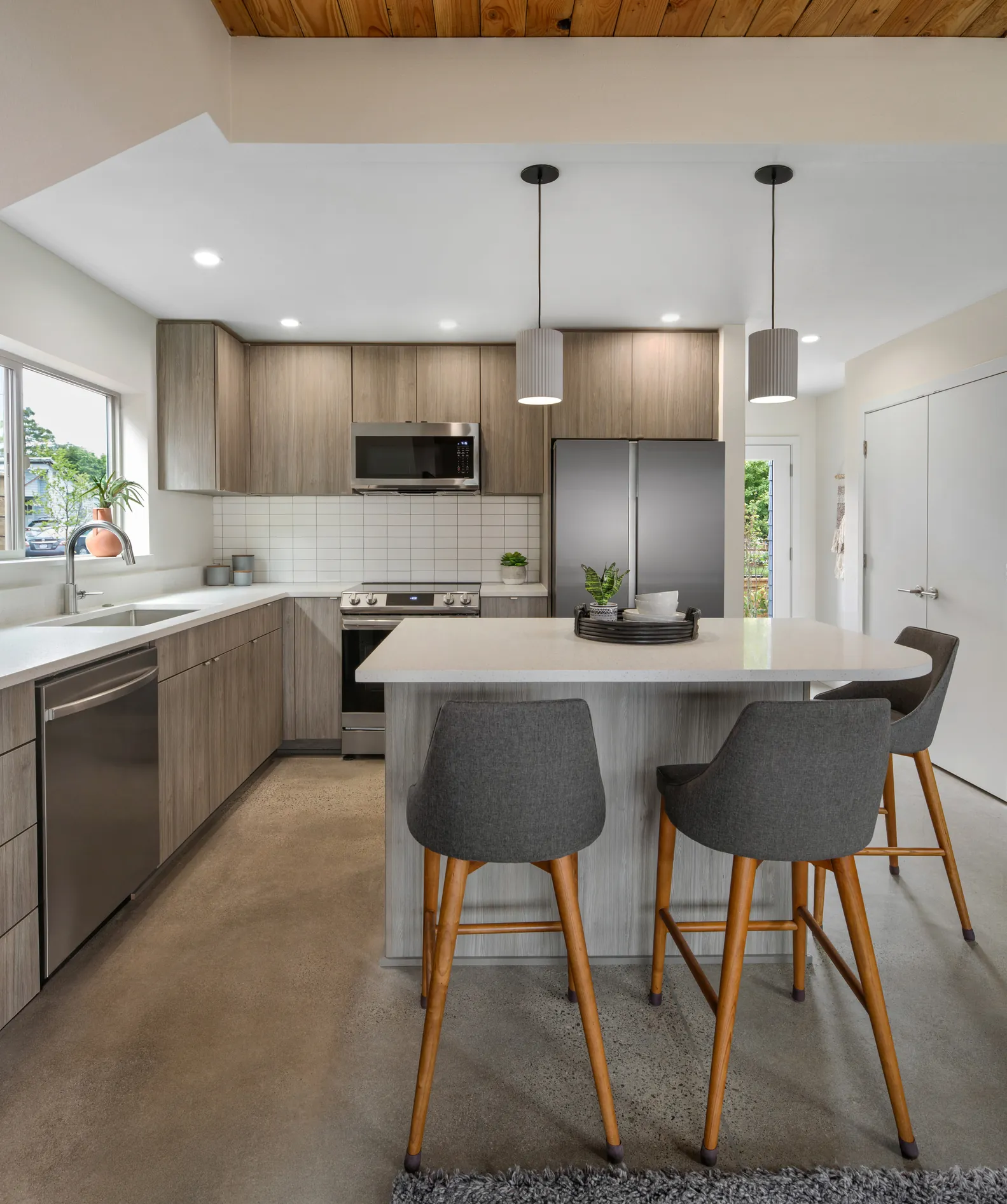 Modern gray kitchen remodel with pendant lighting